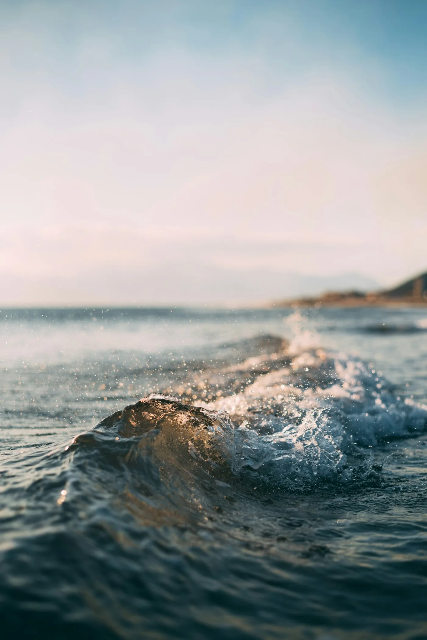 Sunlight and white surf on clear turquoise water