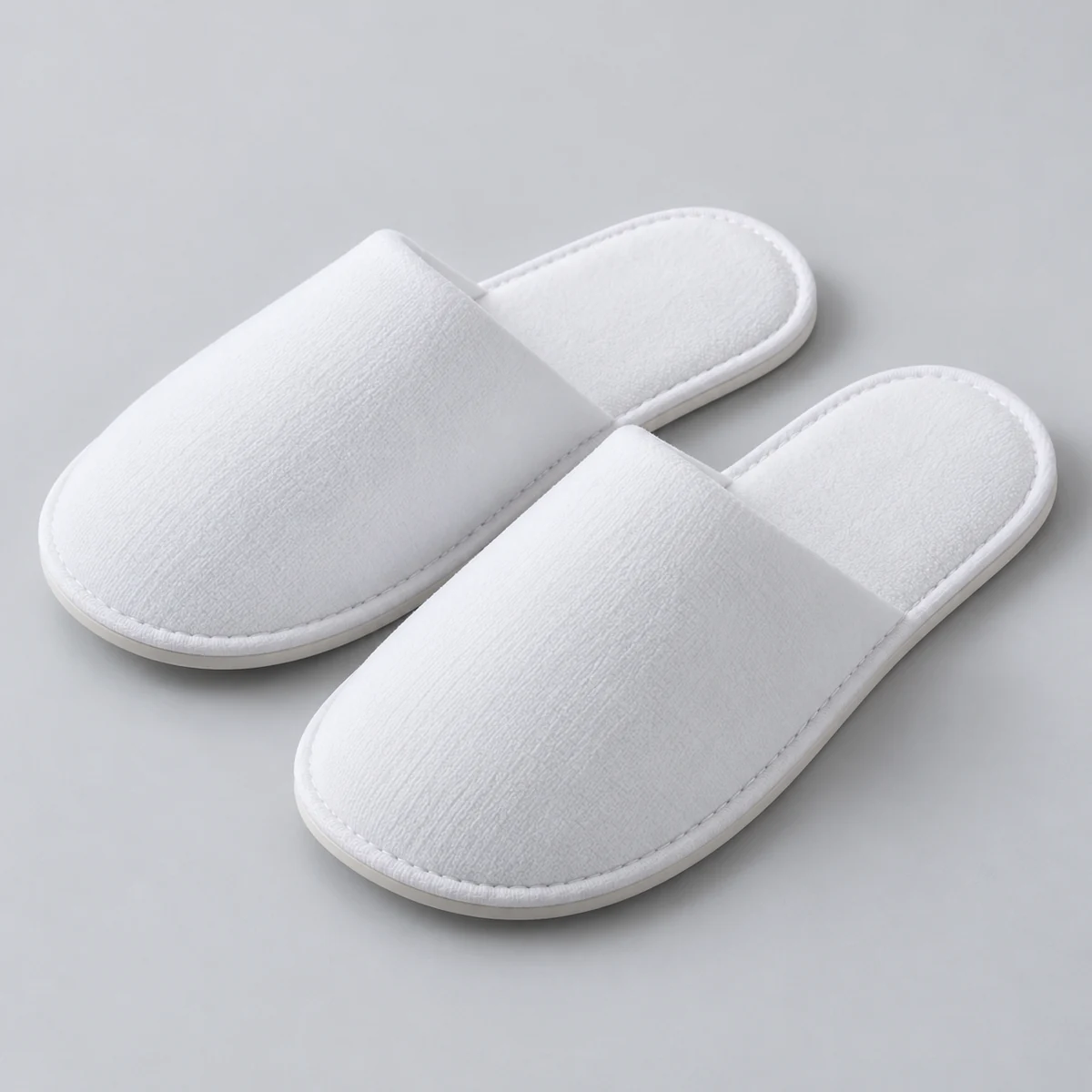 Plain white slipper upper used to illustrate a hotel branding concept